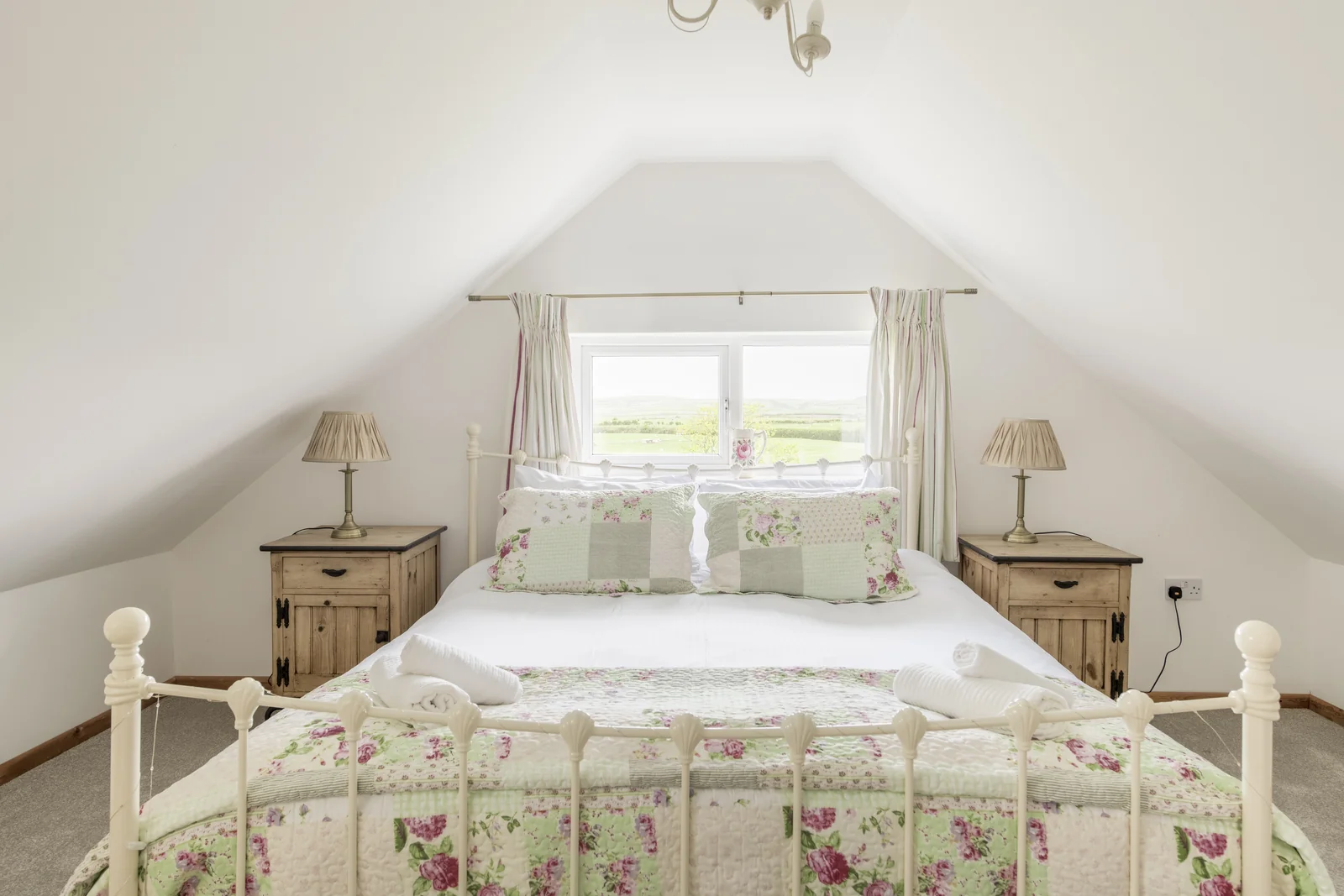 King bedroom with floral furnishings